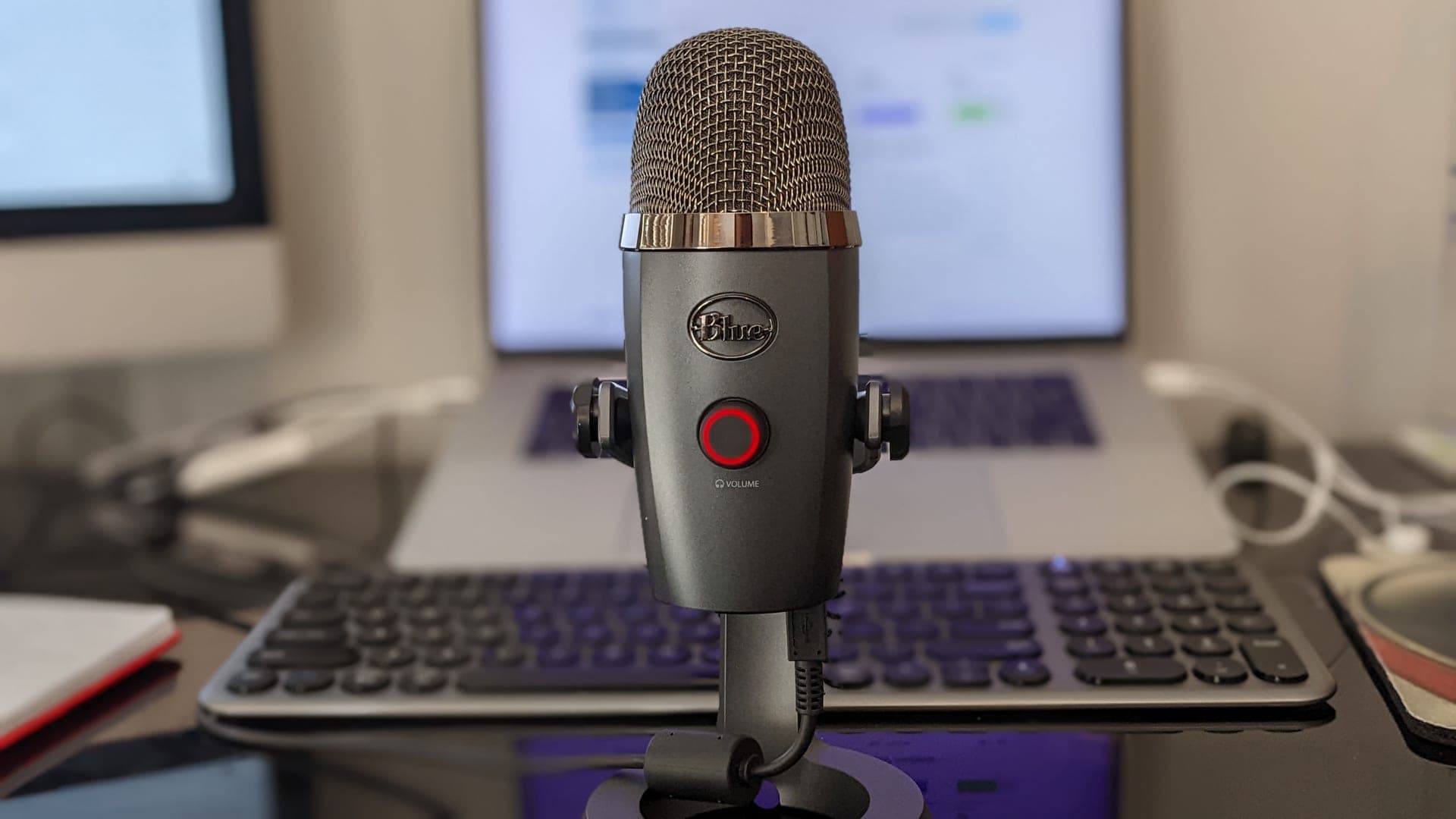 A studio microphone on a desk in soft light
