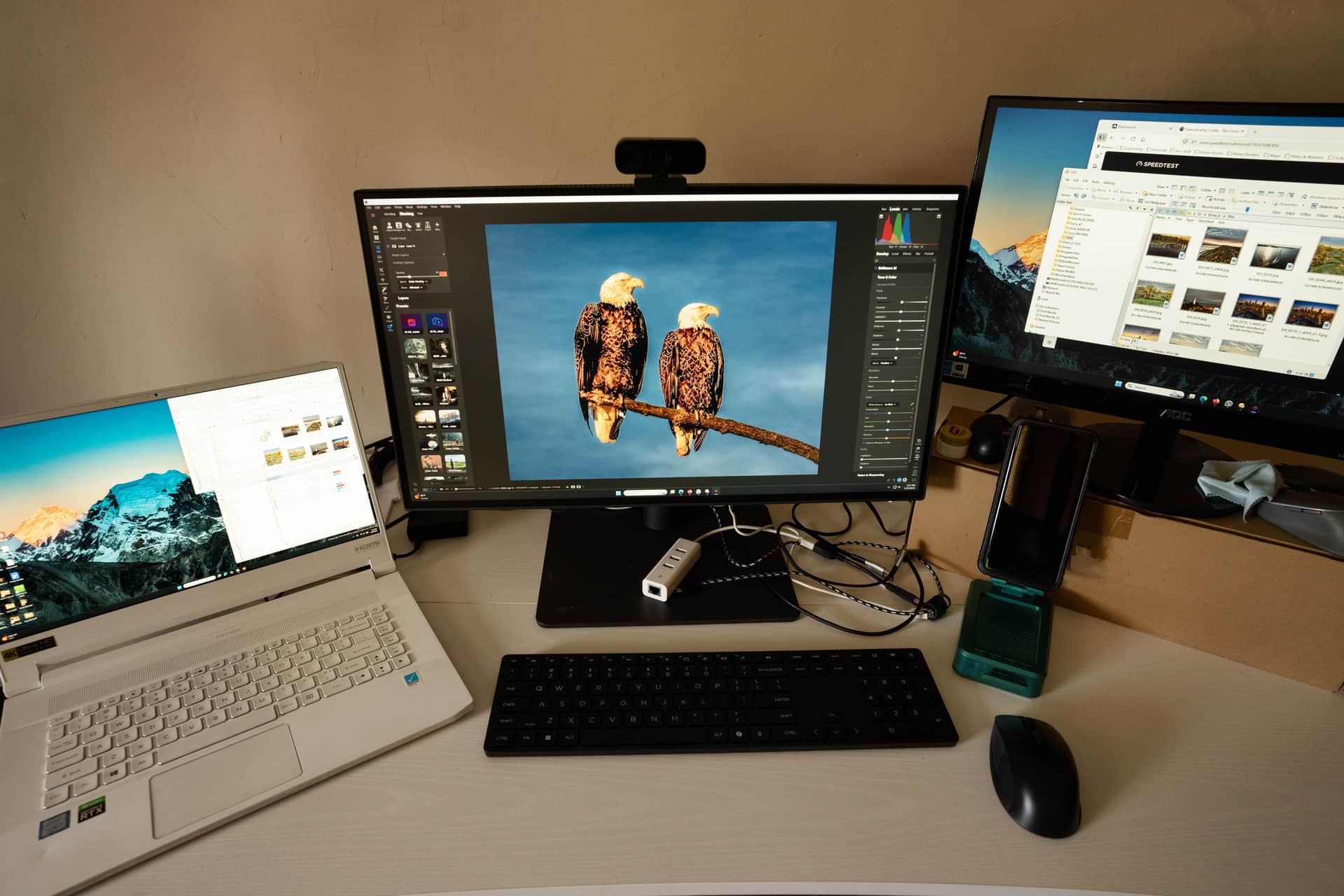 A laptop and monitor set up for photo and video editing