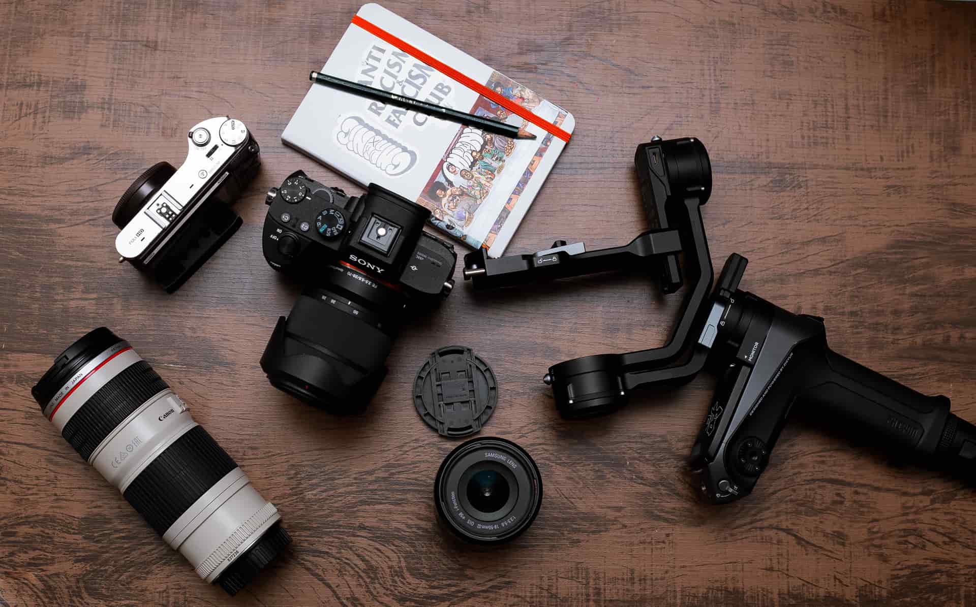 A flat lay of camera gear laid out on a table