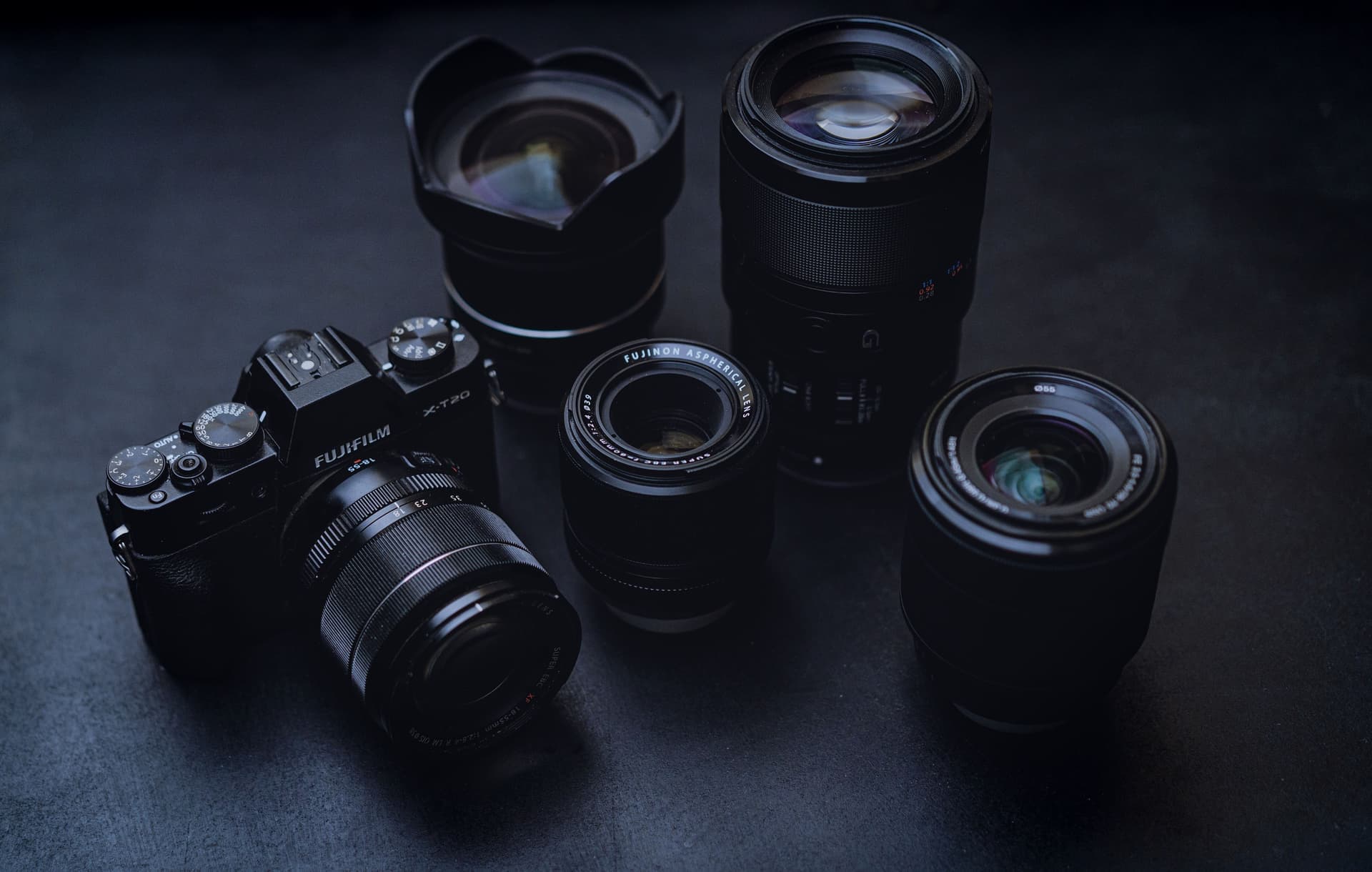Several camera lenses arranged on a neutral surface